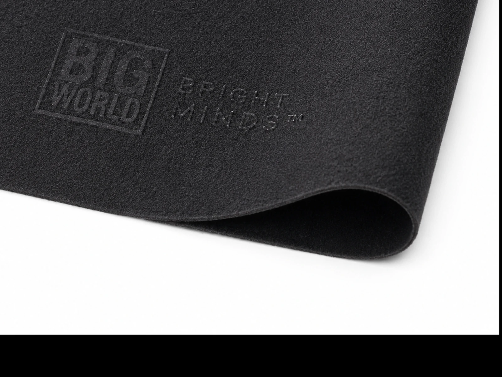 Close-up of black microfiber cloth corner and embossed logo